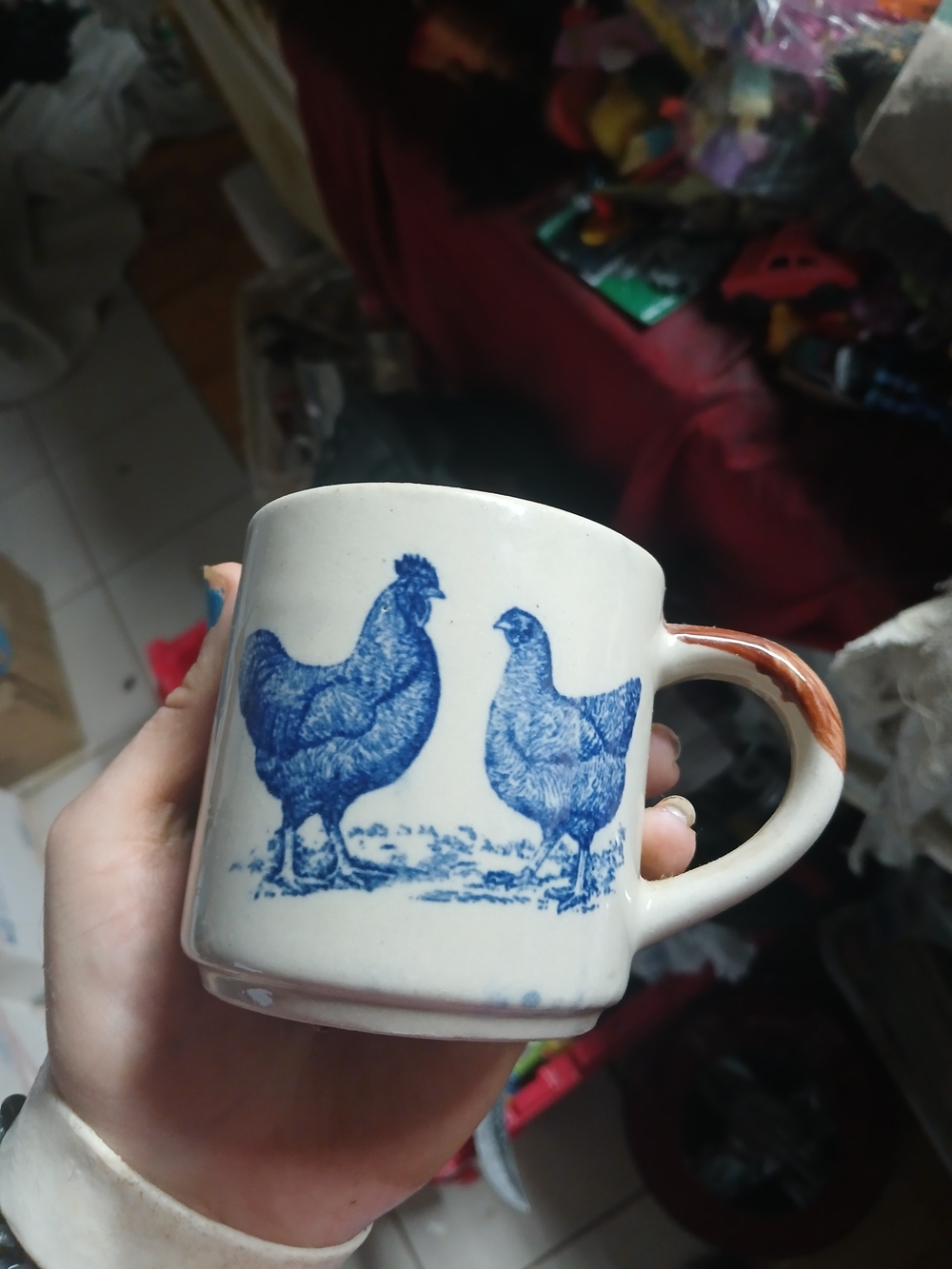 cream-colored ceramic coffee mug featuring a blue transferware print of two chic
